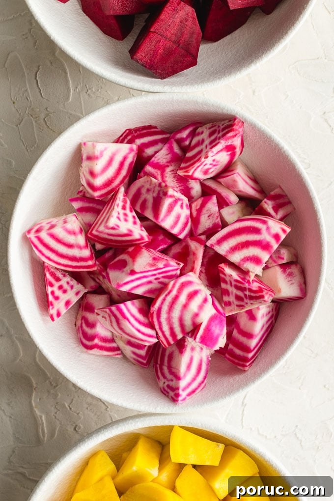 Crispy Air Fryer Roasted Beets: Quick Oven-Free Recipe 6 Up close view of candy cane beets cut into cubes and sitting in a white bowl.