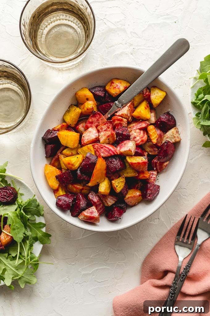 Crispy Air Fryer Roasted Beets: Quick Oven-Free Recipe 7 Air fried beets in a white bowl with a spoon and glasses of water off to the side.