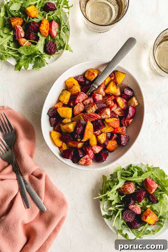 Crispy Air Fryer Roasted Beets: Quick Oven-Free Recipe 8 Overhead view of air fryer roasted beets in a white bowl with plates of arugula and beets off to the sides.