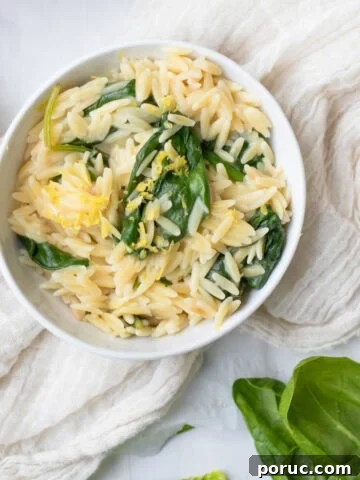 bowl of spinach lemon orzo in a white bowl