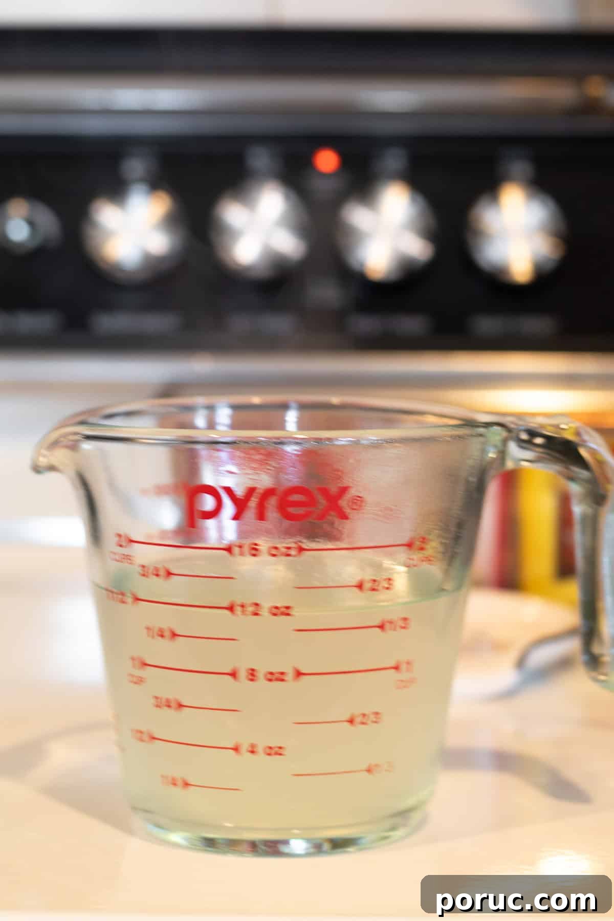 Spinach and Artichoke Pasta Bake with 7 Simple Ingredients 8 pasta water in a measuring cup.