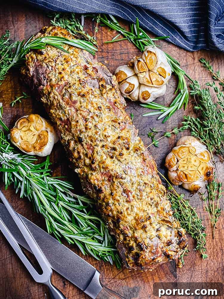 Herb-Crusted Grilled Beef Tenderloin Recipe 2 grilled meat and garlic on a cutting board ready to slice