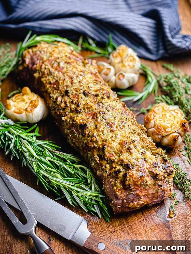 Herb-Crusted Grilled Beef Tenderloin Recipe 8 meat resting on a cutting board