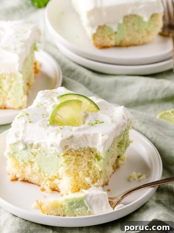 key lime poke cake on 3 plates with limes on the side