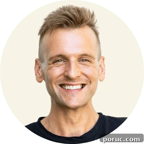 Kaleb Wyse wearing a black shirt standing in front of a taupe background.