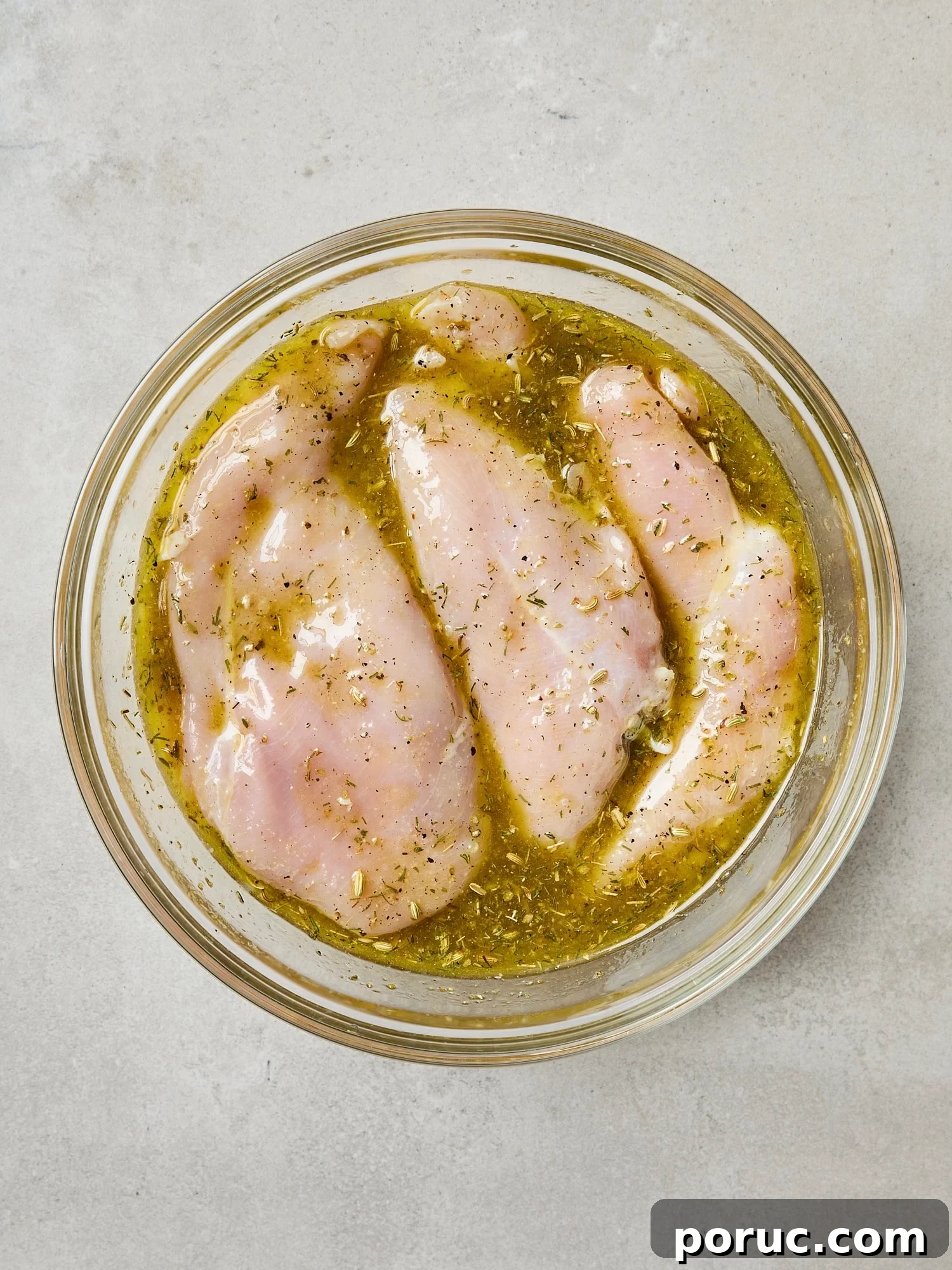 Raw chicken breast submerged in mariade.