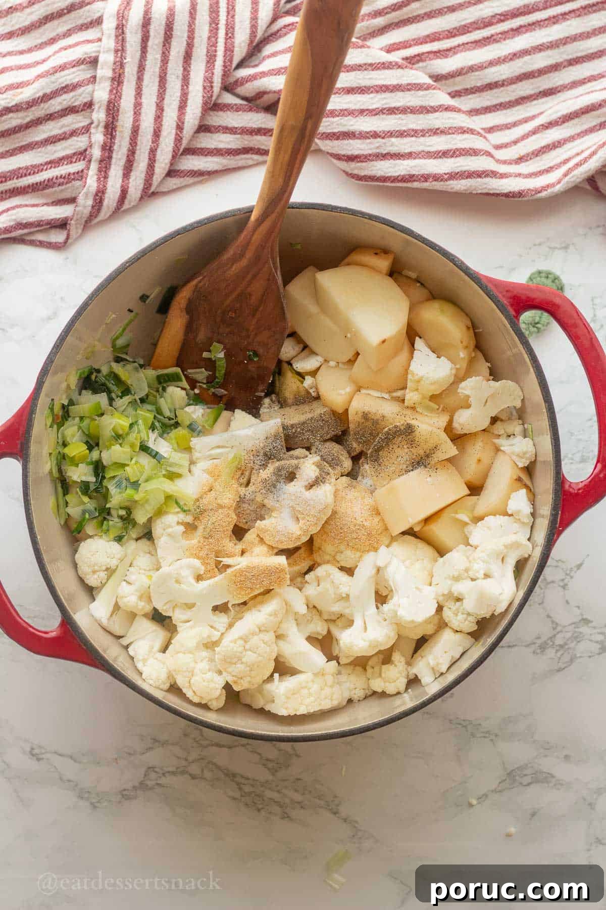 Creamy Potato, Leek & Cauliflower Soup Recipe 5 Raw potatoes and seasonings in pot with cooked leeks.