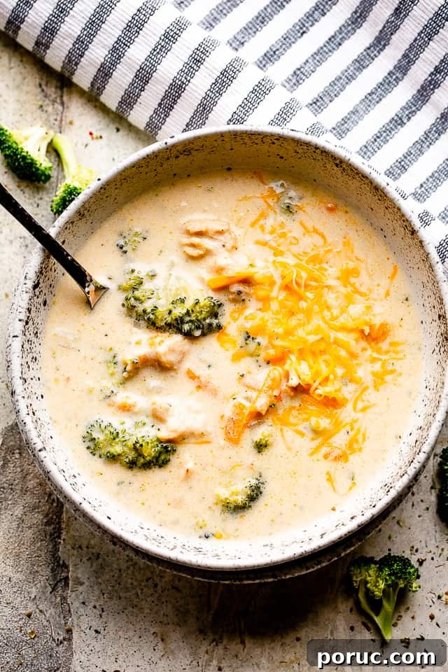 instant pot broccoli cheese soup in a soup bowl with spoon.