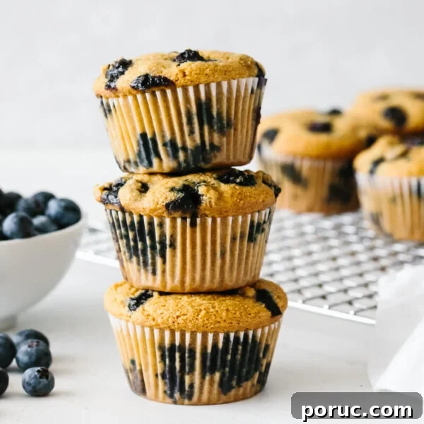 Paleo blueberry muffins stacked on top of each other.