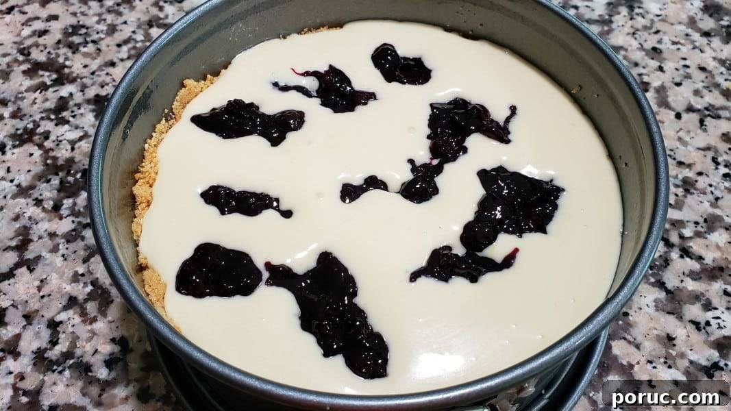 Lemon Blueberry Cheesecake Recipe: Creamy No-Bake Dessert 8 blueberry swirl sauce dropped randomly into lemon cheesecake filling in a 7 inch springform pan.