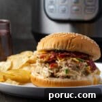 Landscape photo of a creamy crack chicken burger with bacon, cheddar, and chives.