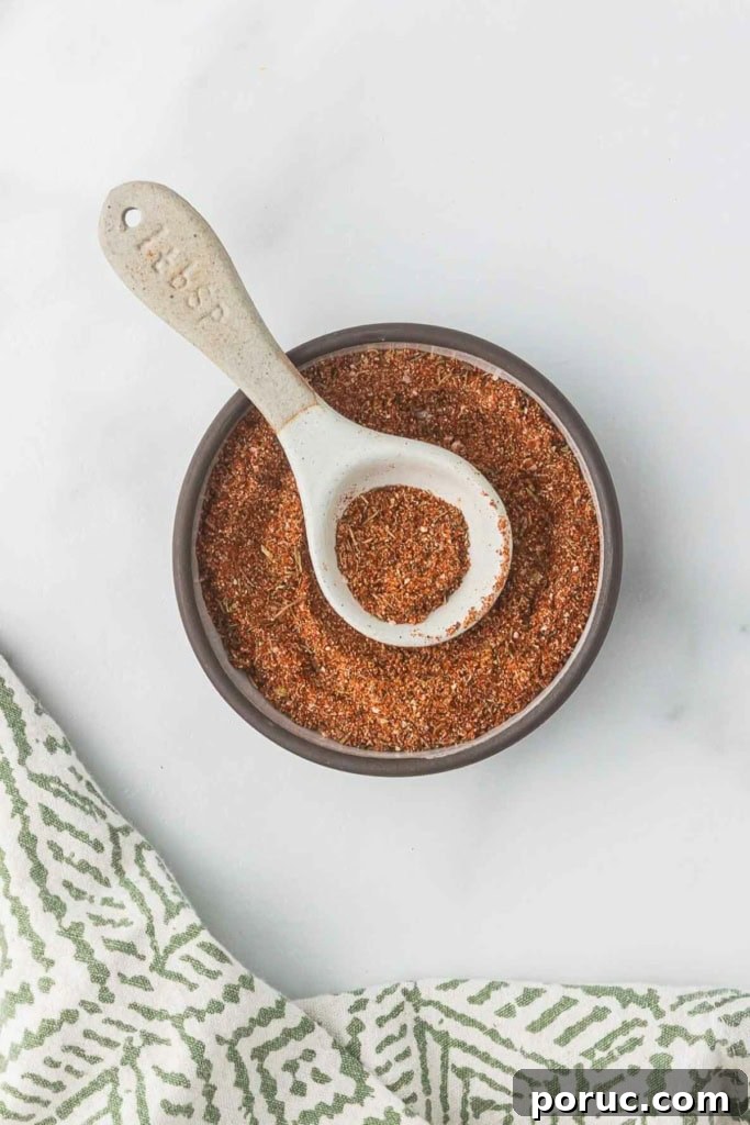 Quick 3-Minute Homemade Blackening Seasoning Mix for Bold Flavor 5 blackening seasoning in a small glass bowl with a spoon