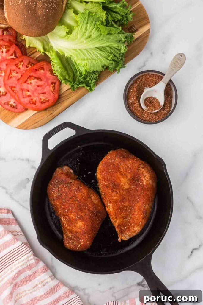 Quick 3-Minute Homemade Blackening Seasoning Mix for Bold Flavor 6 blackening seasoning rubbed on chicken breasts in a cast-iron skillet