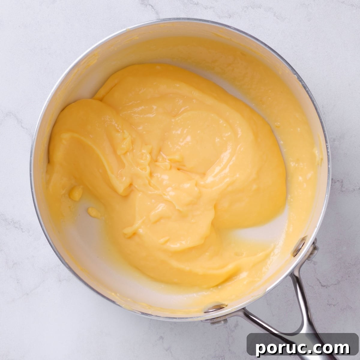 pan with homemade lemon curd cake filling.
