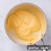 close up view of lemon curd in a pan ready for filling bakery style cakes.